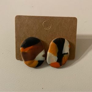 Black white and orange stud earrings